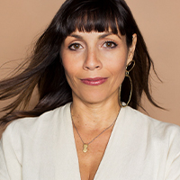 A woman with light brown skin and long dark brown hair.