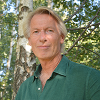 An older white man with short blond hair.