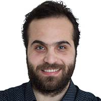 A man with light skin and black short hair and facial hair.