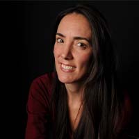 A woman with light skin and long dark hair.