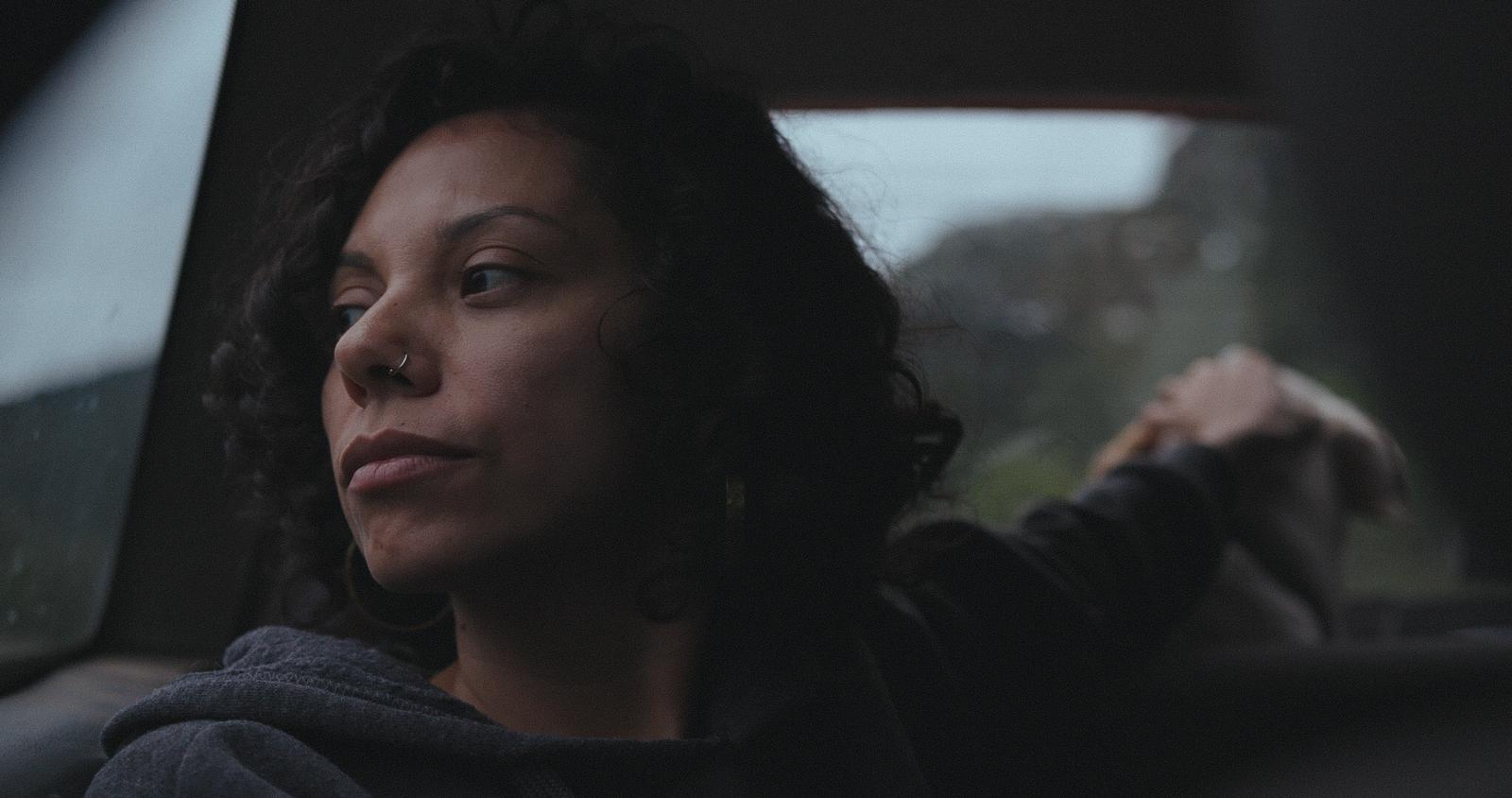 Jasmín Mara López is a Latin American woman with short wavy hair, sitting in a car looking out the window. From Mara López's 'Silent Beauty.'  Courtesy of BlackStar  Film Festival.