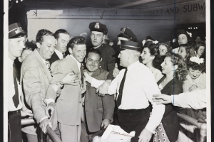 A 1943 NYWTS photo of Frank Sinatra mobbed by fans, found in the Library of Congress. The photo's cutline reads: "It took all these Pasadena, Calif., policemen, if you can believe the story, to rescue singer Frank Sinatra from the hordes of fans that beseiged him when he got off his train at Pasadena. Looks like that old black magic is really taking hold in California."