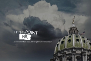An image of a green dome with an American flag in the bottom right corner, and dark clouds in the background. The text "Tipping Point PA" is superimposed on the clouds in white text.