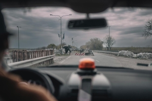 Still from 'In the Rearview,' depicting a view of a road blockade from the inside of a van.