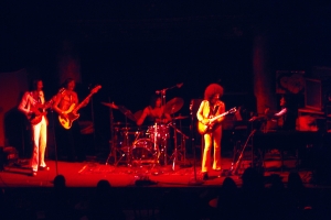 Slightly blurry image of a band performing.