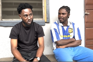 Two young men sitting on a veranda