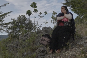  Mariano´s mother in her traditional clothes from Chamula and surrounded by the mountains of his home town calls him by cellphone. 