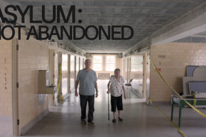 A senior aged brother and sister walking down the hallway of an empty wing at the Sheboygan County Hospital.