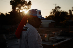 Silhouette of Altadena resident at sunset standing on the foundation of his property