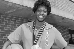 Lusia Harris, a Black woman with short black hair, wearing wearing several Olympic medals. A still from Ben Proudfoot's 'The Queen of Basketball'. Courtesy of NY Times Op-Docs