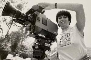 An Association of Professional Camerawomen member in the mid-1980s using a 1982 Ikegami HL-79D portable electronic camera.