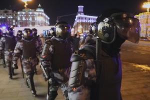 Heavily armed troops, wearing body armor, face shields and helmets, march through the streets of Moscow at night. From Gesbeen Mohammed’s ‘Putin’s War at Home,’ a ‘Frontline’ production currently streaming on PBS.org. Courtesy of ‘Frontline’.