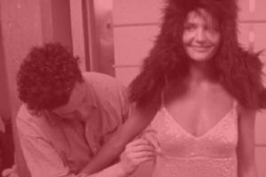 Isaac Mizrahi unzips a woman's dress from Douglas Keeve's 'Unzipped.'