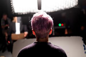 The back of a woman with pink hair's head.