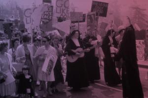 A group of people protesting, including several nuns in black robes.