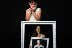 A child is holding a frame within a frame.