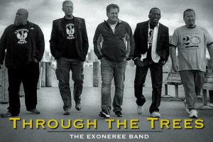 Five middle-aged men walk down the boardwalk in "exoneree band" t-shirts.