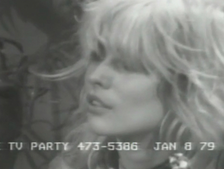 Black and white still dated January 8 1979 of a blond young white woman next to a microphone