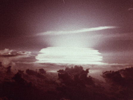 Blurry red-hued shot of an atomic blast