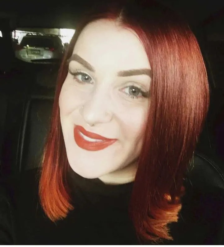 Headshot of a young adult female of Caucasian descent with red hair