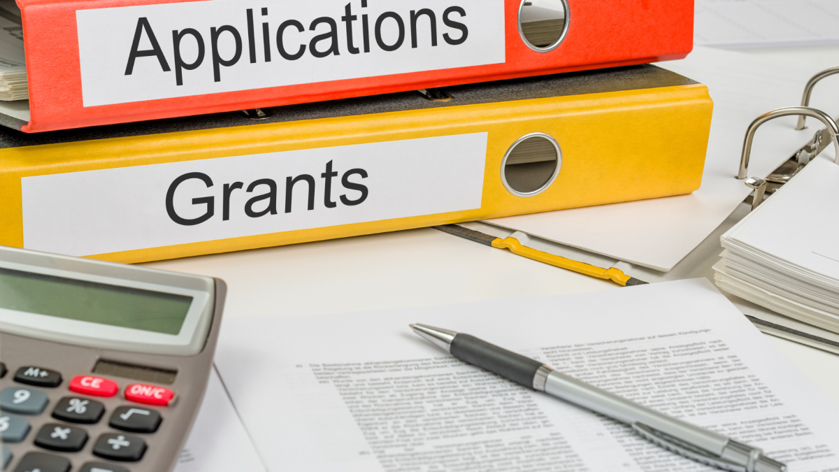 Image of two binders labeled Applications and Grants