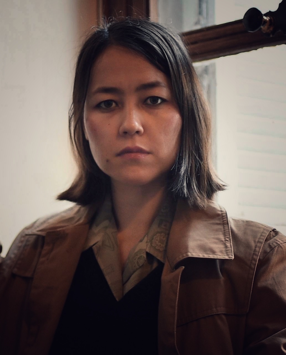 headshot of Hawa director, Najiba Noori wearing a brown jacket