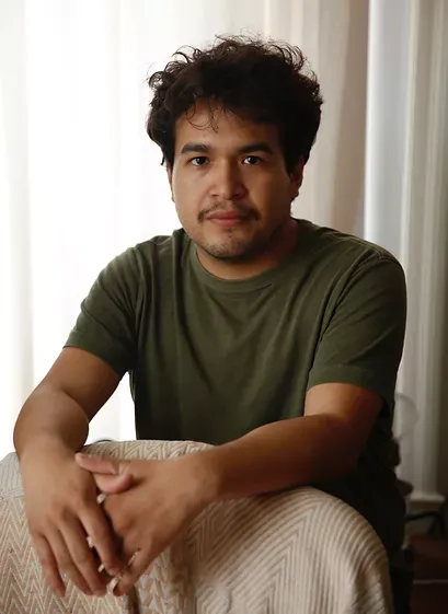 headshot of JoeBill Muñoz wearing an olive green shirt 