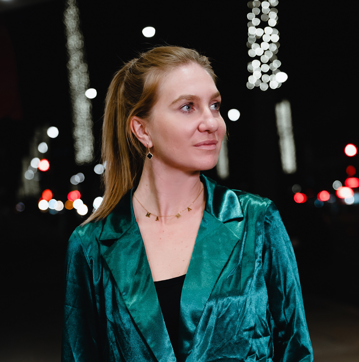 headshot of Polina Herman wearing a green jacket over a black shirt