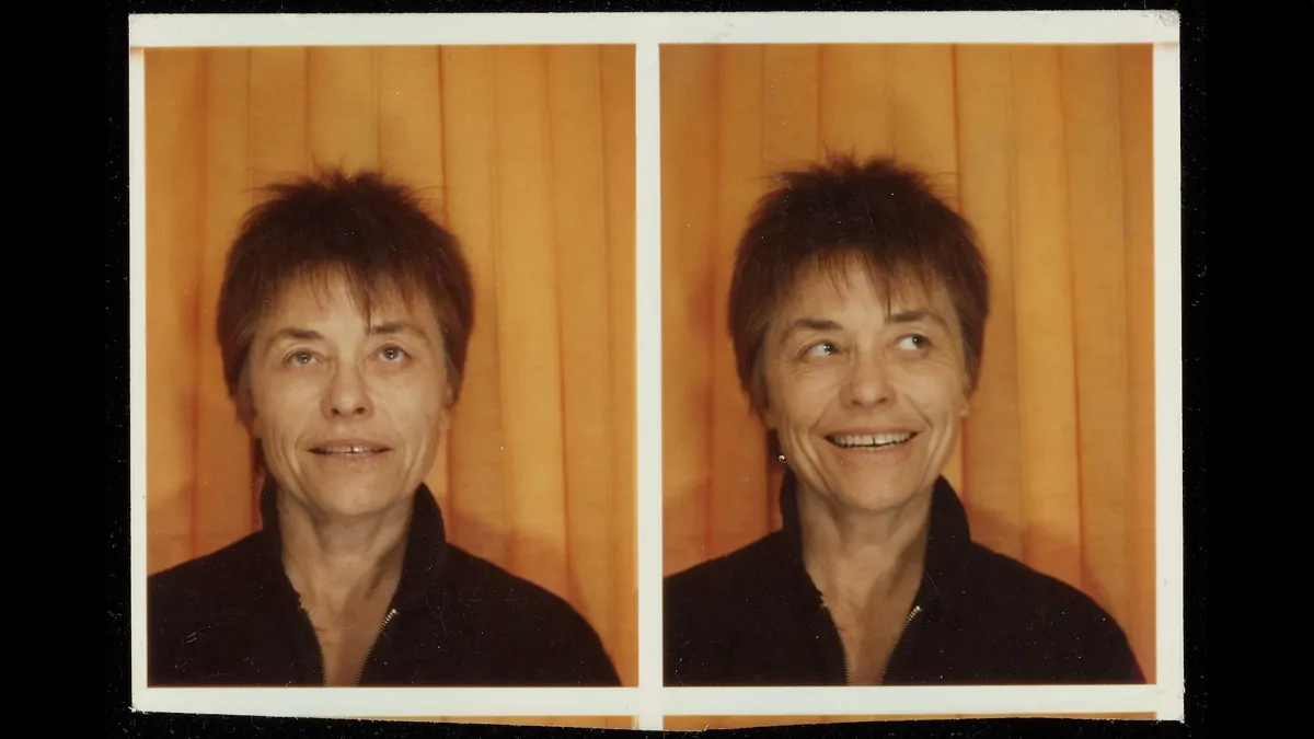 Two printed photos of a middle-aged white woman with short spiky auburn hair making two different expressions 