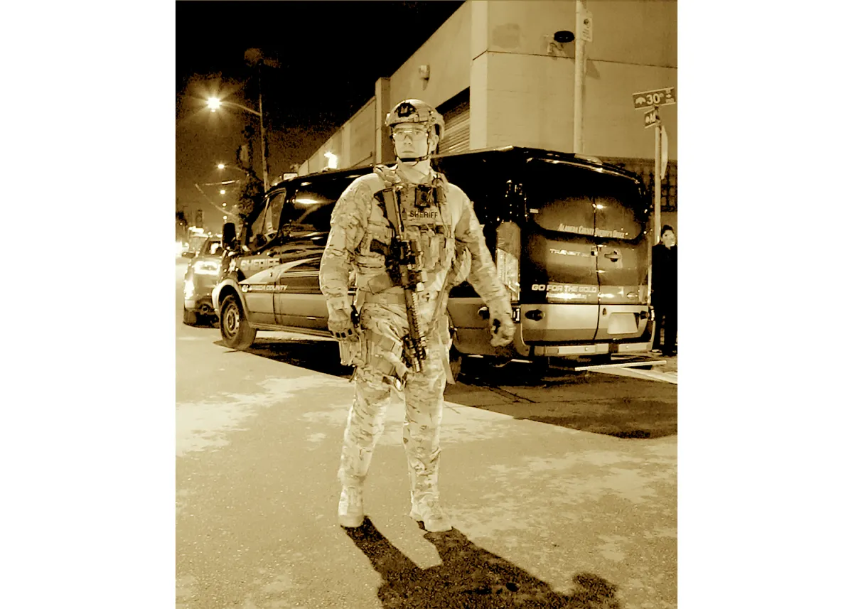 Sepia image of a sheriff in riot gear