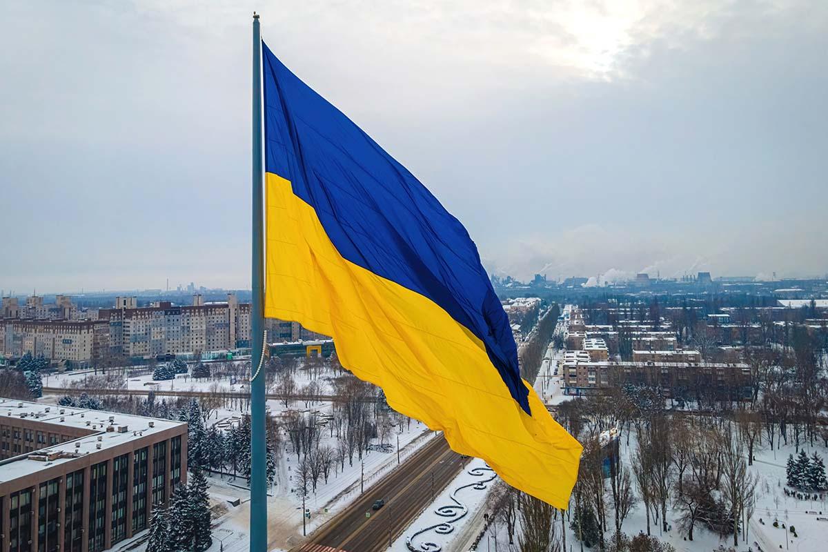 The Ukrainian flag flying over a city.