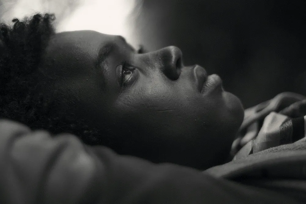 Mohammed Arif, a boy from Ethiopia, lies on his back with eyes looking up at the sky. Image from Jessica Beshir's 'Faya Dayi.' Courtesy of Cinetic Media. 