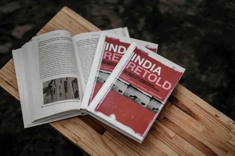  The cover of 'India Retold: Dialogues with Independent Documentary Filmmakers in India,' a compilation of commentary from 30 contemporary documentary filmmakers, is red, with black-and-white photos. 