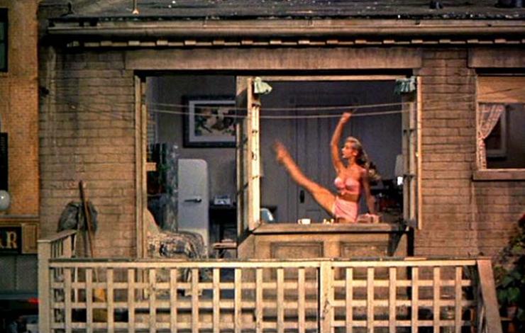 A dancer poses in a window with an arm and leg extended upward. 'Voyeur' is loosely based on Hitch­cock's 'Rear Window' (photo).