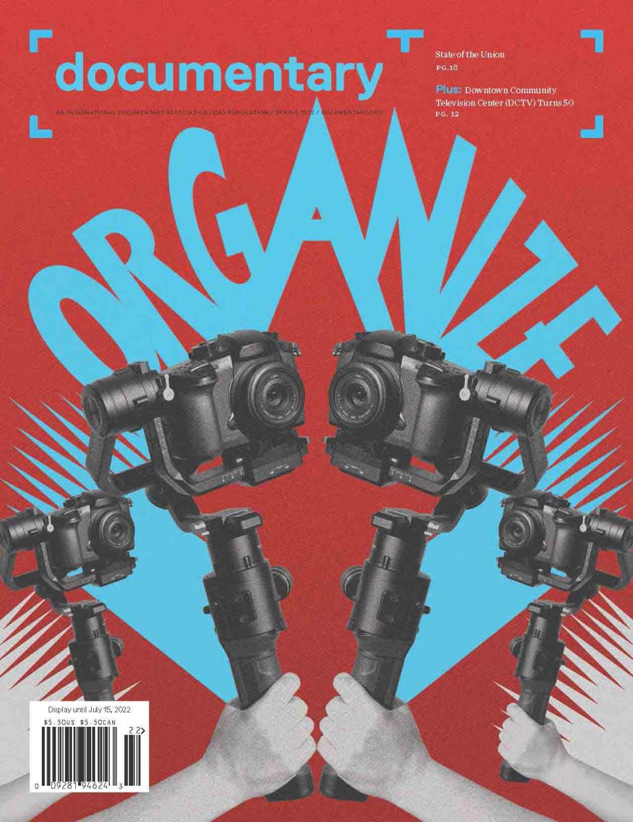 The IDA Spring 2022 Issue cover features a red background with blue text and design elements, and four arms holding up cameras in the air. 