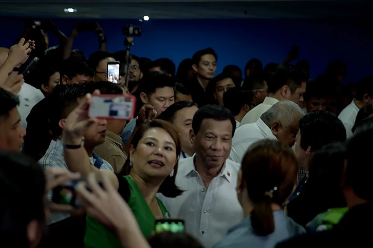 crowds surround Philippine President
