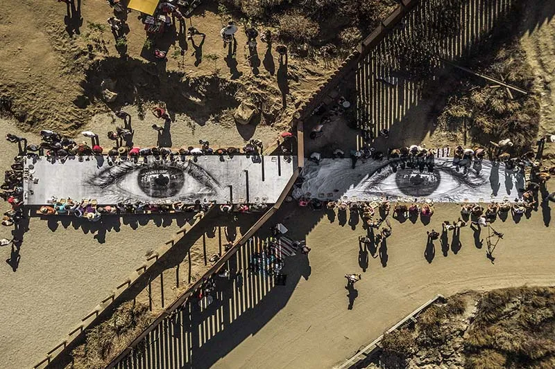 A birds eye view of a large mural of two eyes.