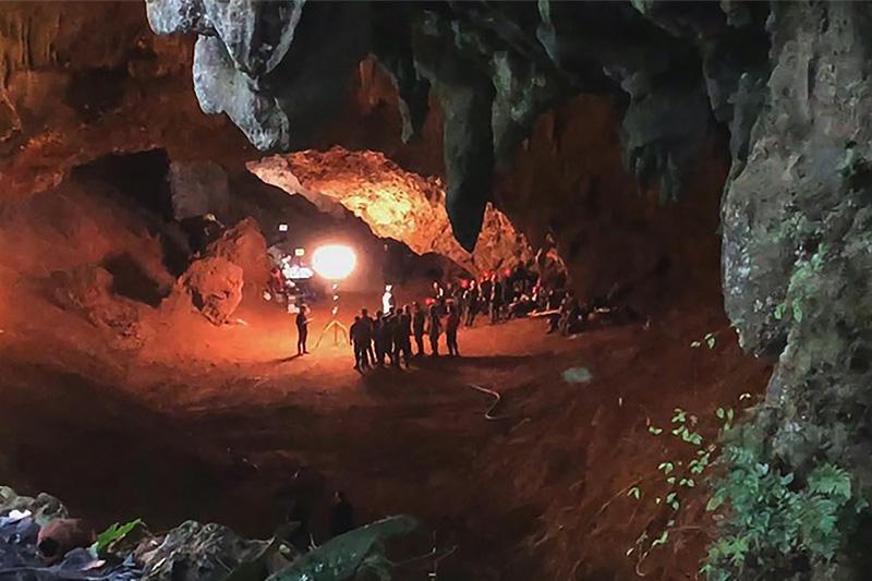 A group of people inside a dark cave.