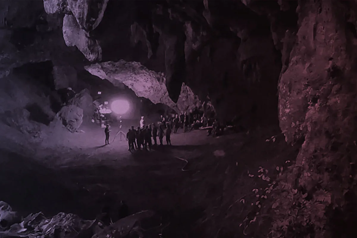 Several people inside a dark cave.