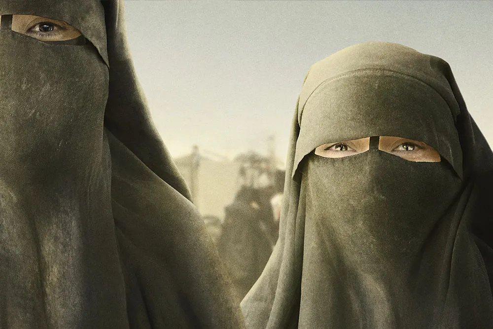 Two animated women in black niqabs.