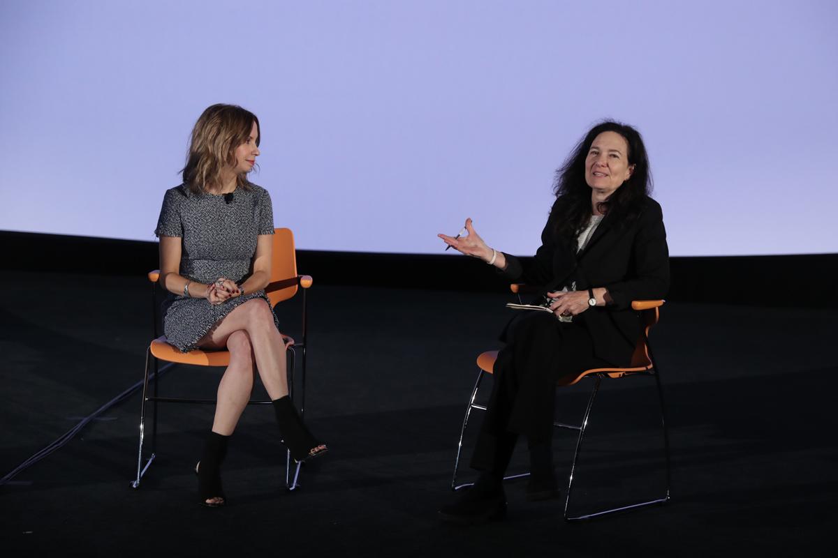 Caty Borum Chattoo (left) and Sally Jo Fifer (right) sitting on orange chairs next to each other.