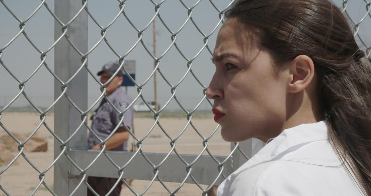 AOC looks through chainlink fence of detention center