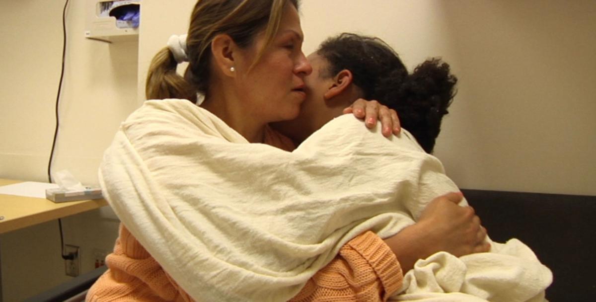 A mother hugs her daughter in a psychiatric hospital