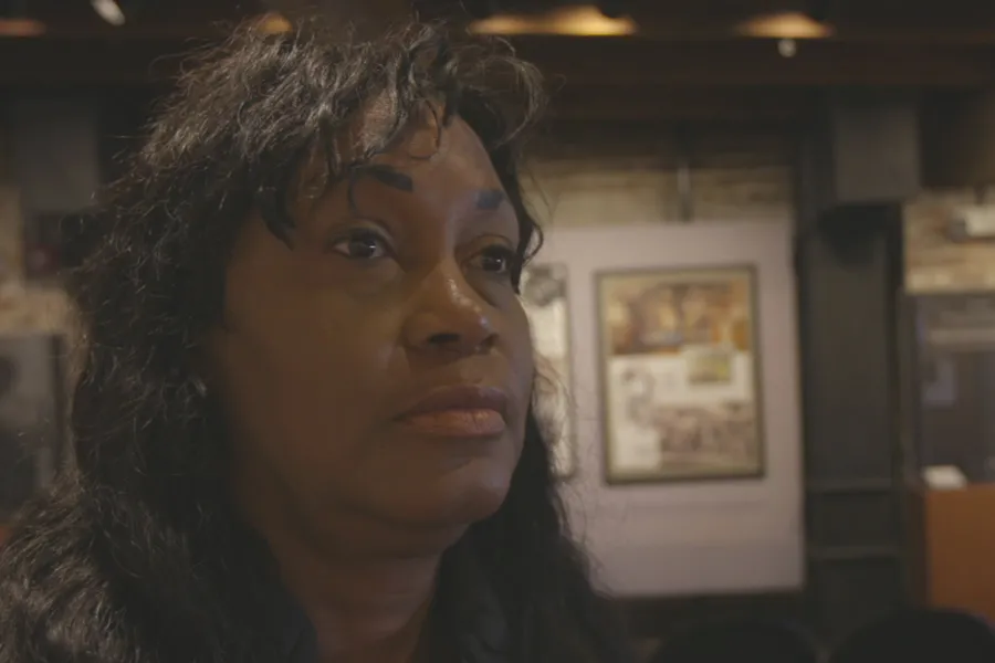 main character and descendant of Renty gazes past camera in deep thought