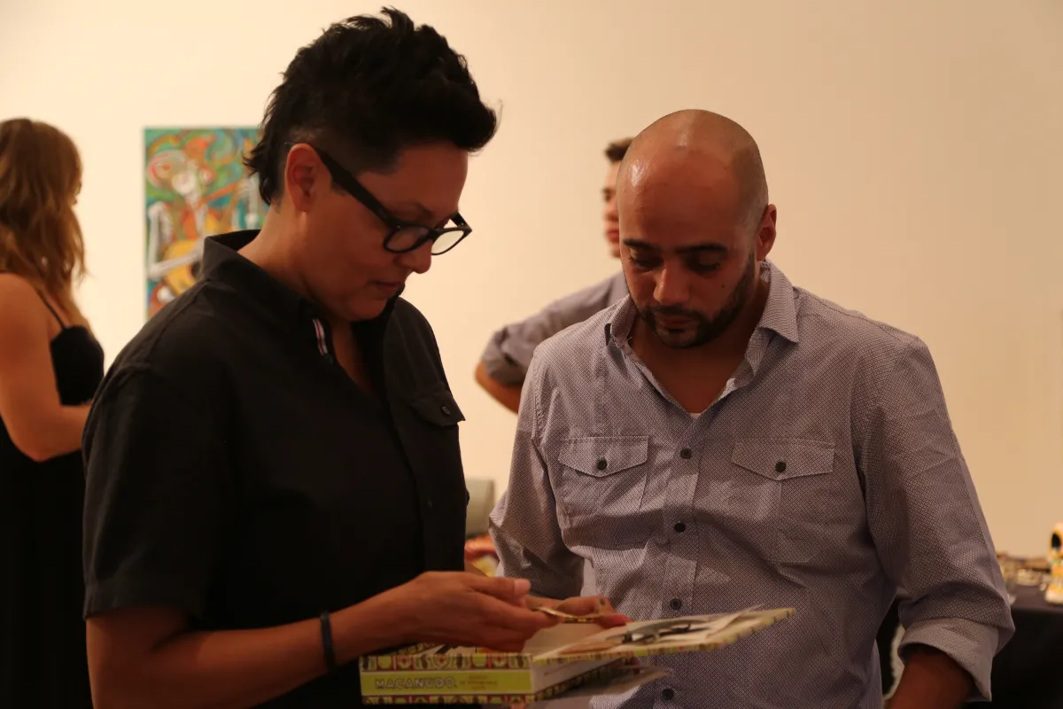 Two people looking at an open box.