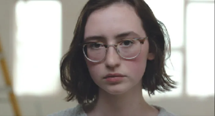 A photo of a female Caucasian with glasses.