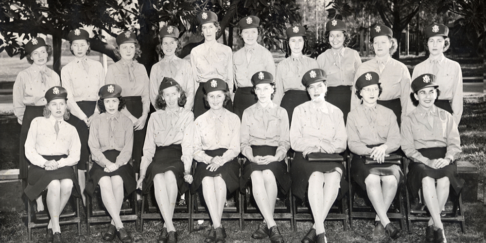 A large seated portrait of 18 WWII-era female military nurses