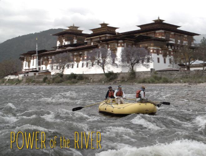 a yellow raft floats down the rapids of a Bhutanese river with a large building on the distant shore.
