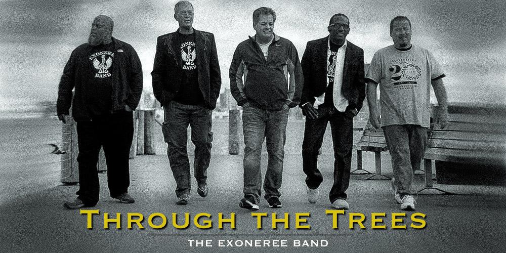 Five middle-aged men walk down the boardwalk in "exoneree band" t-shirts.