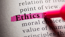 The word "Ethics" highlighted with pink marker on a book page
